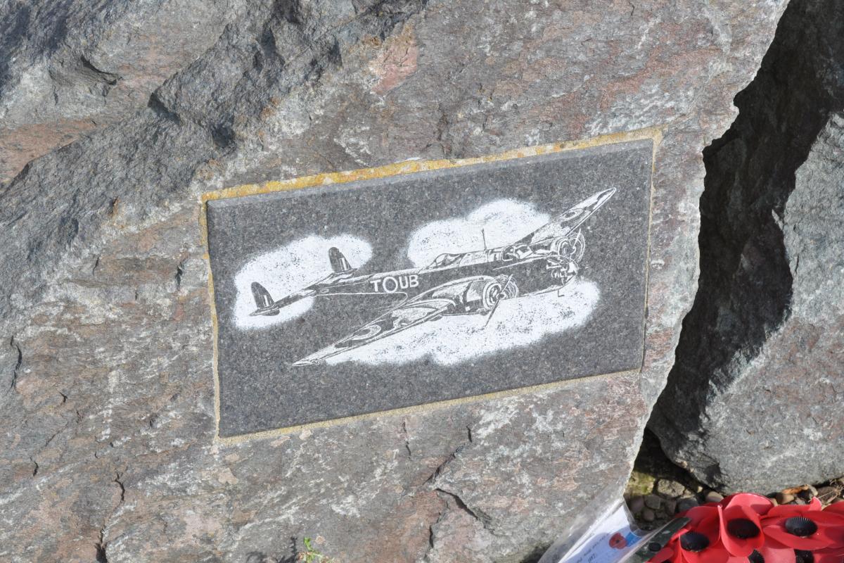 Close-up of a memorial stone at Saltby, with an engraving of a British Hampden bomber