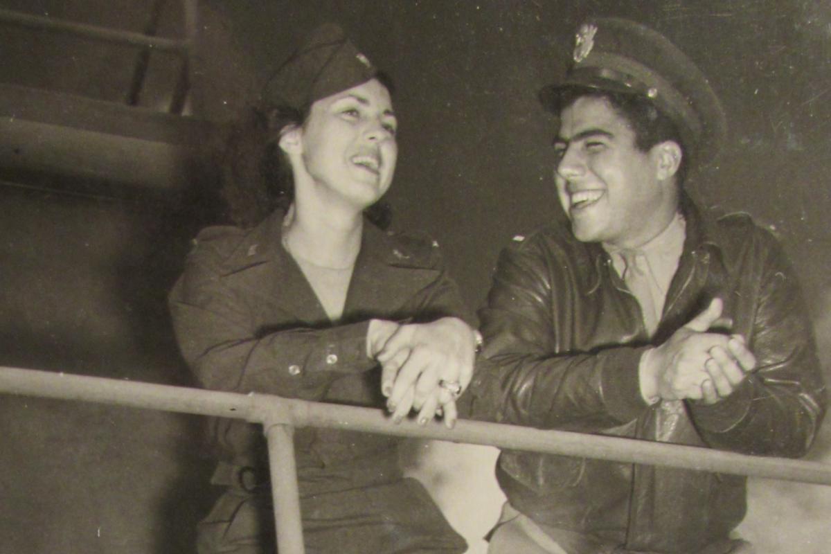 Jerry and Vito chatting on the balcony of a control tower