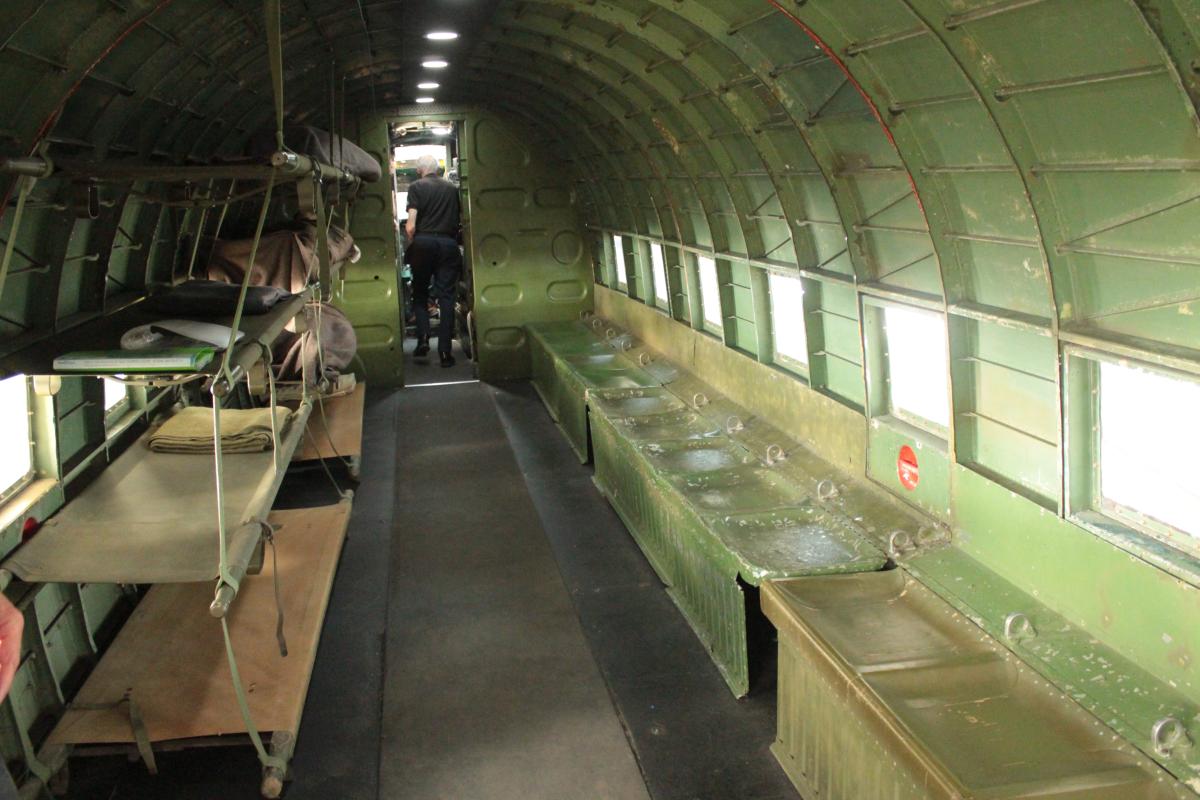 Inside the C-47: on the left are stretchers prepared for casualty evacuation; on the right are the standard bucket-type paratrooper seats