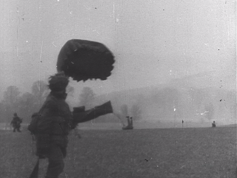 British paratroops walking across a dropzone after a training jump