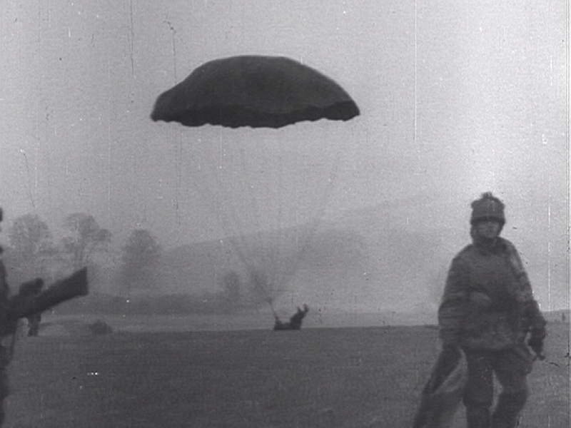 A British paratrooper lands on his back during a training jump