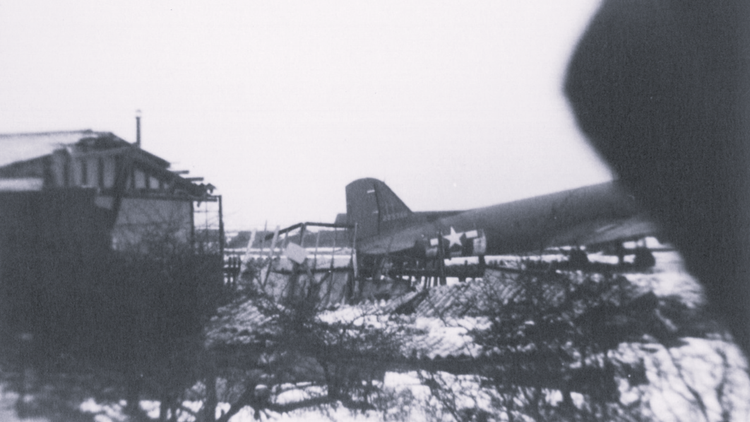 Photo showing a building struck by the C-47 when it failed to stop after landing