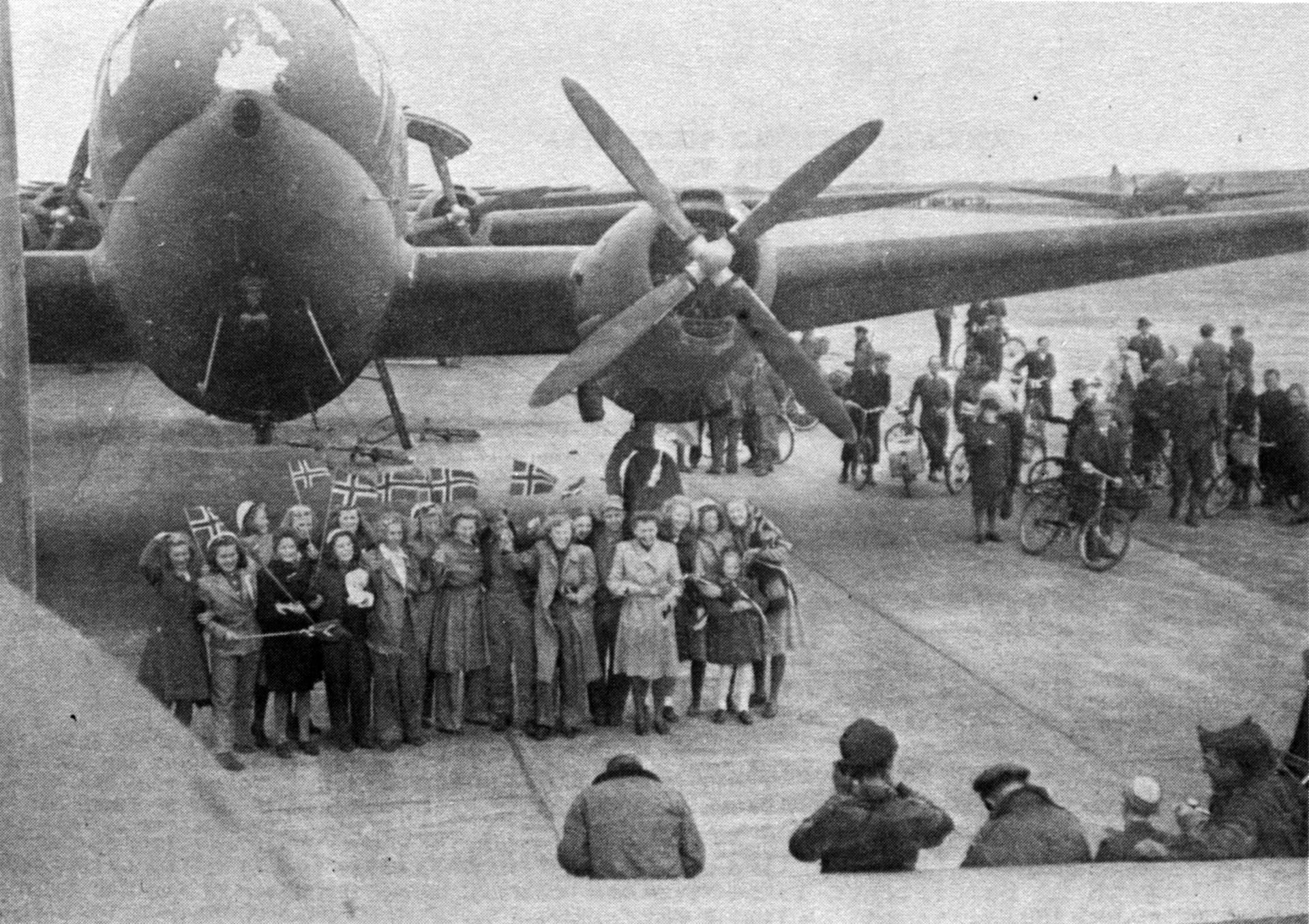 Norwegian civilians welcome a C-46 aircraft