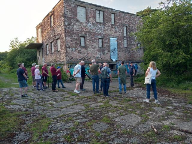 A group is shown the wartime control tower at North Witham airfield