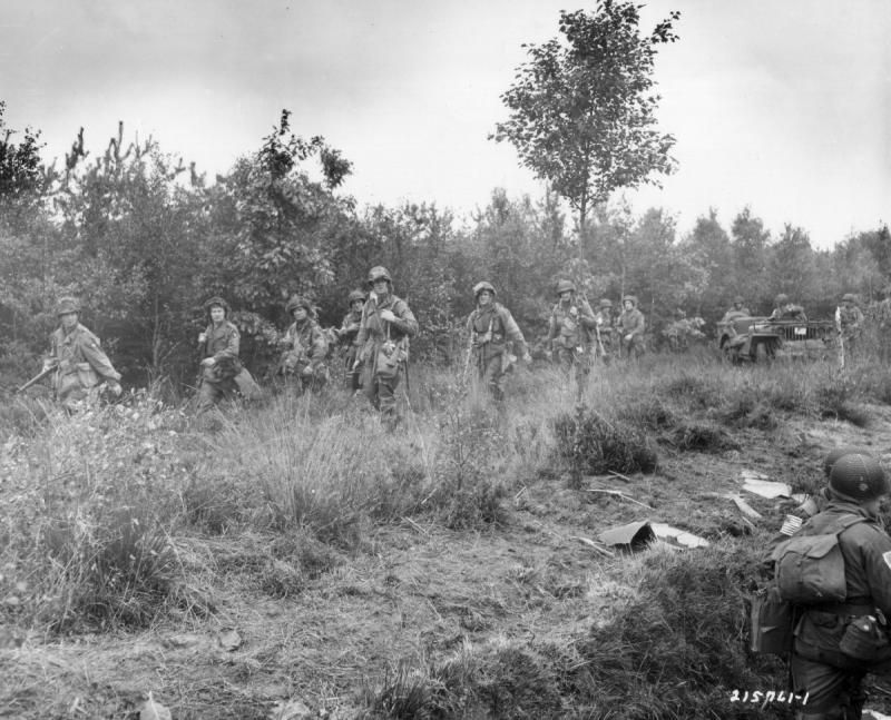 Paratroopers advancing through the countryside