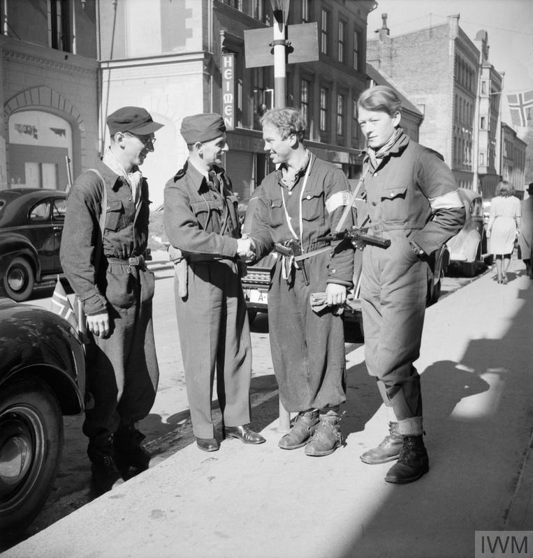 An RAF officer speaking with three Norwegian resistance fighters in Oslo