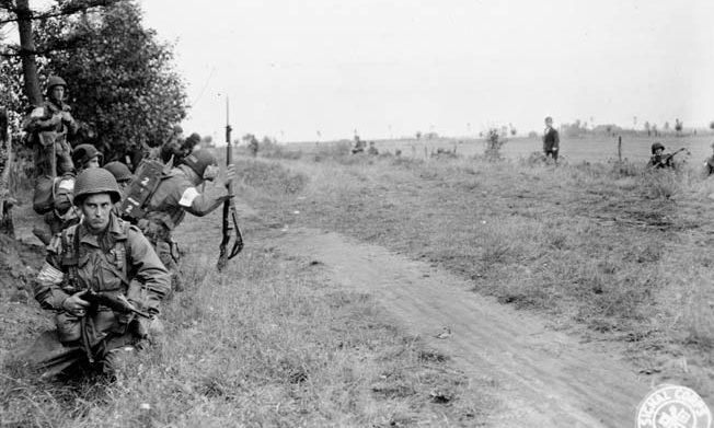 Paratroopers of the US 101st Airborne Division line a track in the Netherlands