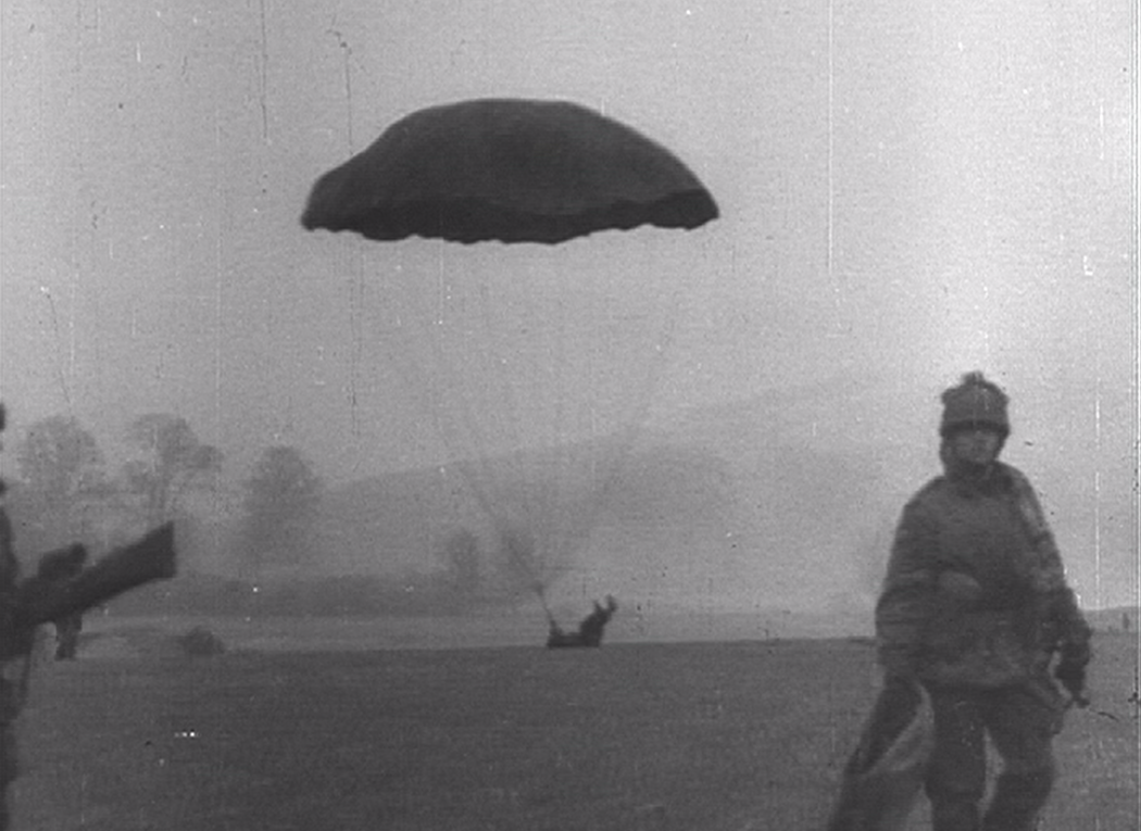 A British paratrooper lands on his back during a training jump